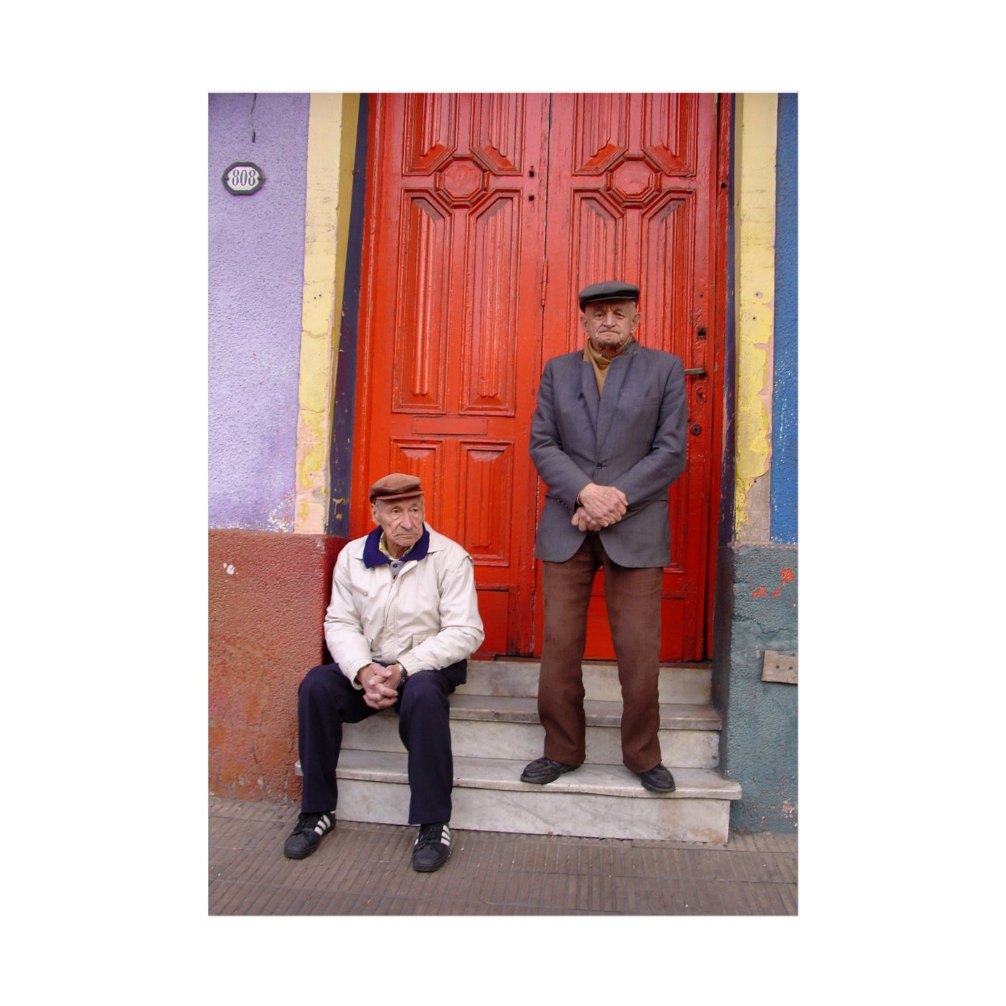 Two Men at the Red Door — La Boca Street Portrait | "Argentinidad" Exhibition | Rômulo Fritscher